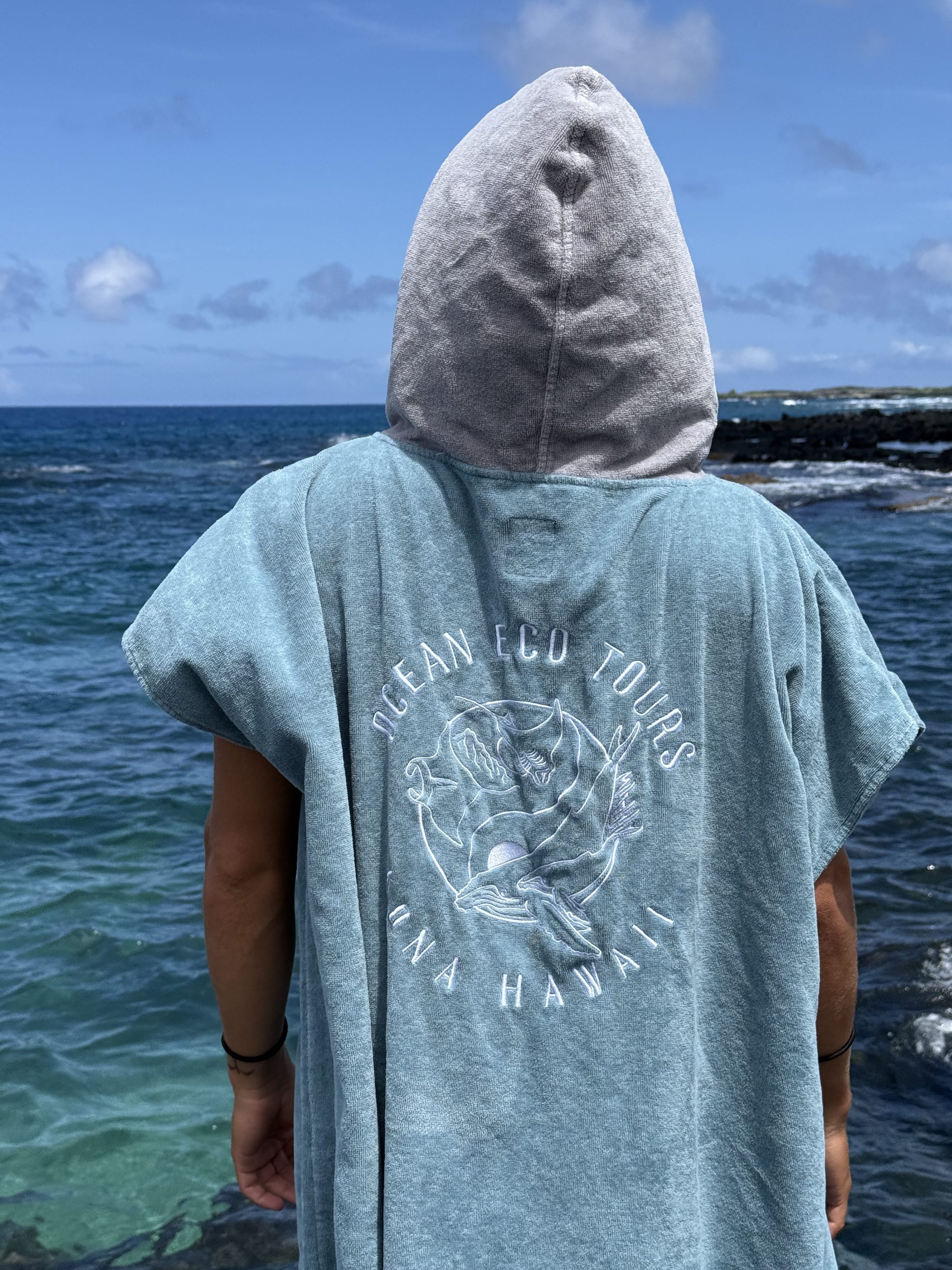 a statue of a man standing next to a body of water