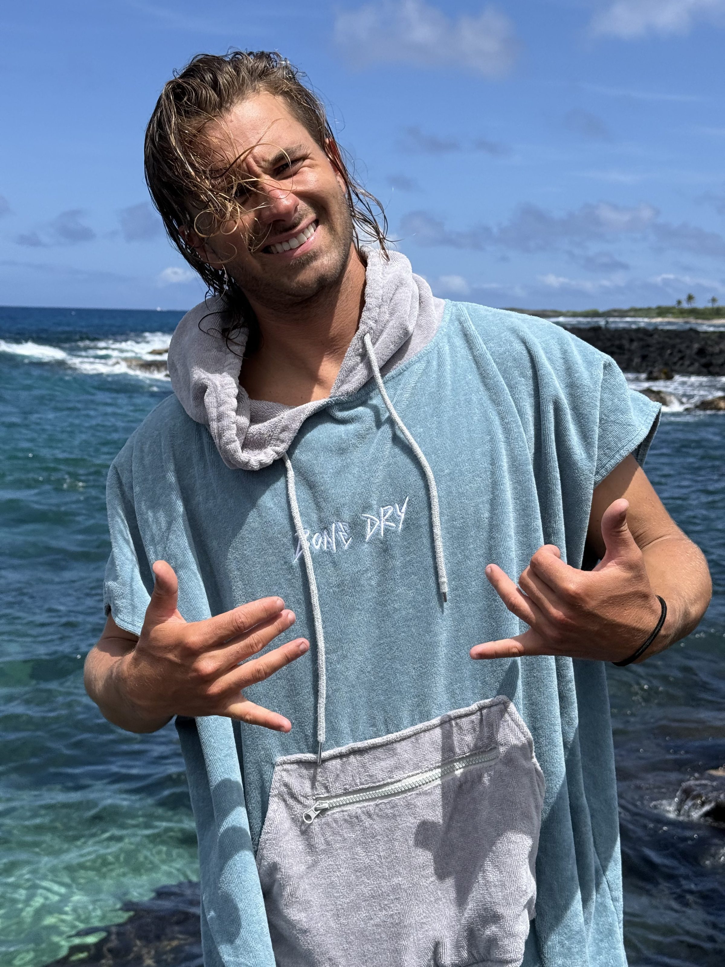 a man standing next to a body of water